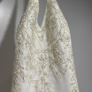 Ivory in color. Never worn except to try on. Size 12 has never been altered.